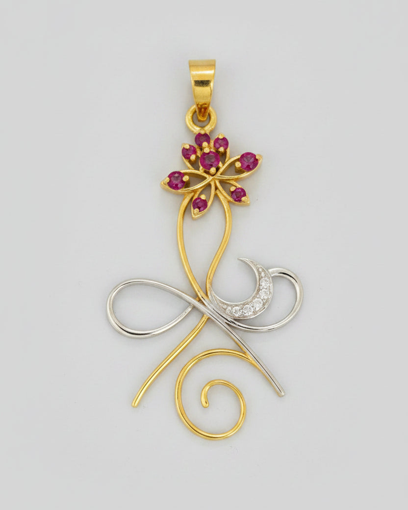 A gold and silver metal pendant featuring a stylized design with a lotus flower embellished with pink gemstones.