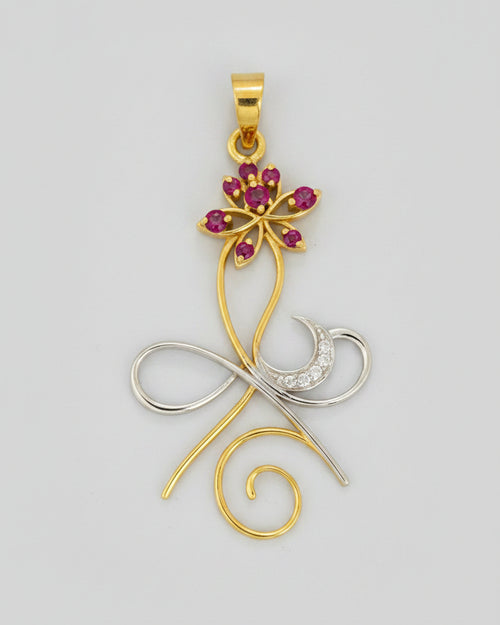 A gold and silver metal pendant featuring a stylized design with a lotus flower embellished with pink gemstones.