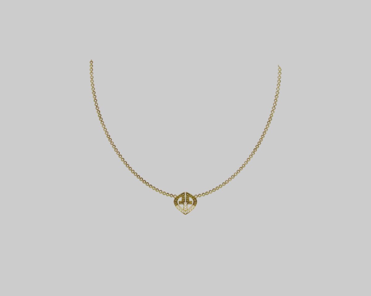A delicate gold chain necklace with a small geometric pendant featuring a stylized 'V' design.