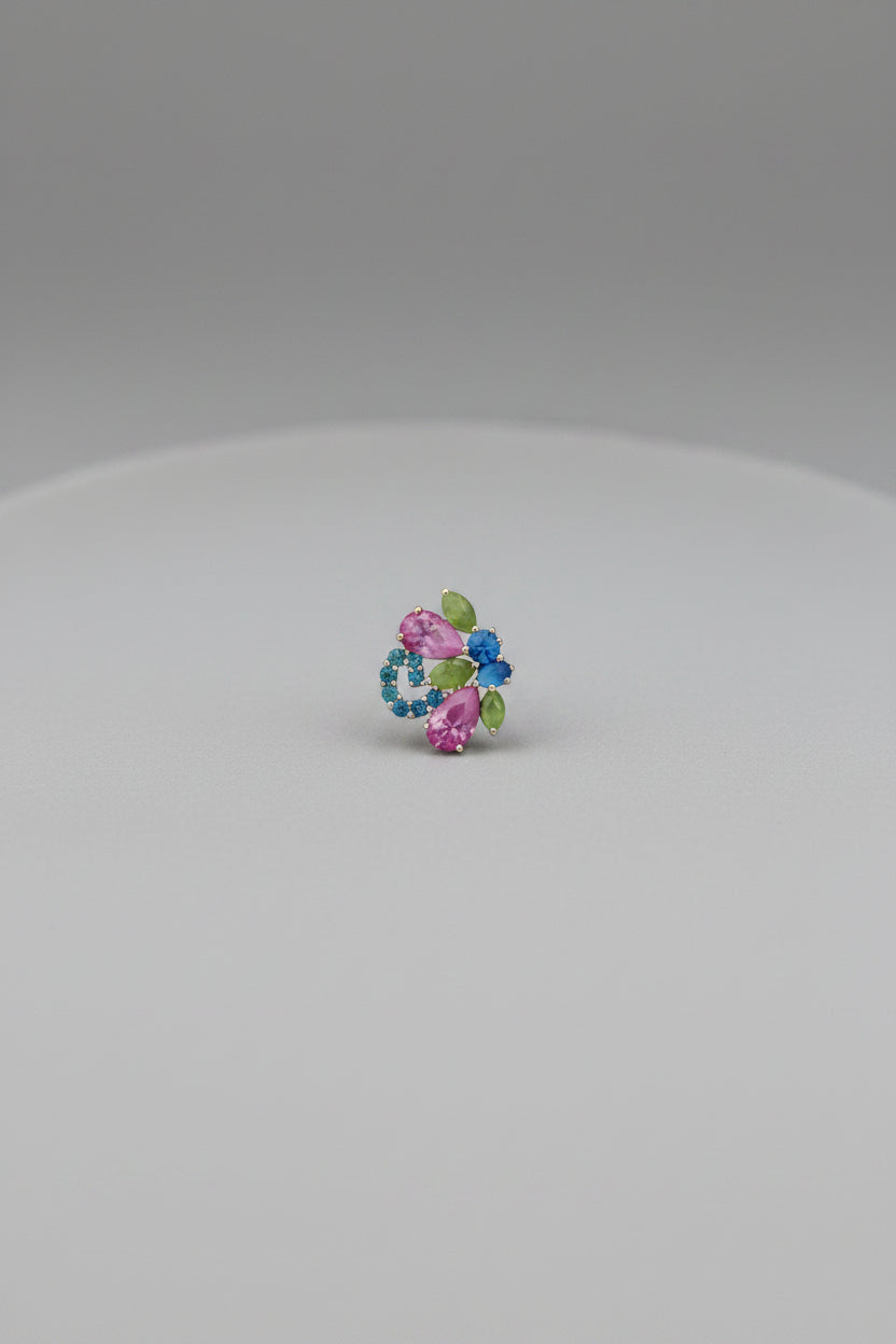 A small multicolored circular accessory or charm centered on a solid black background.
